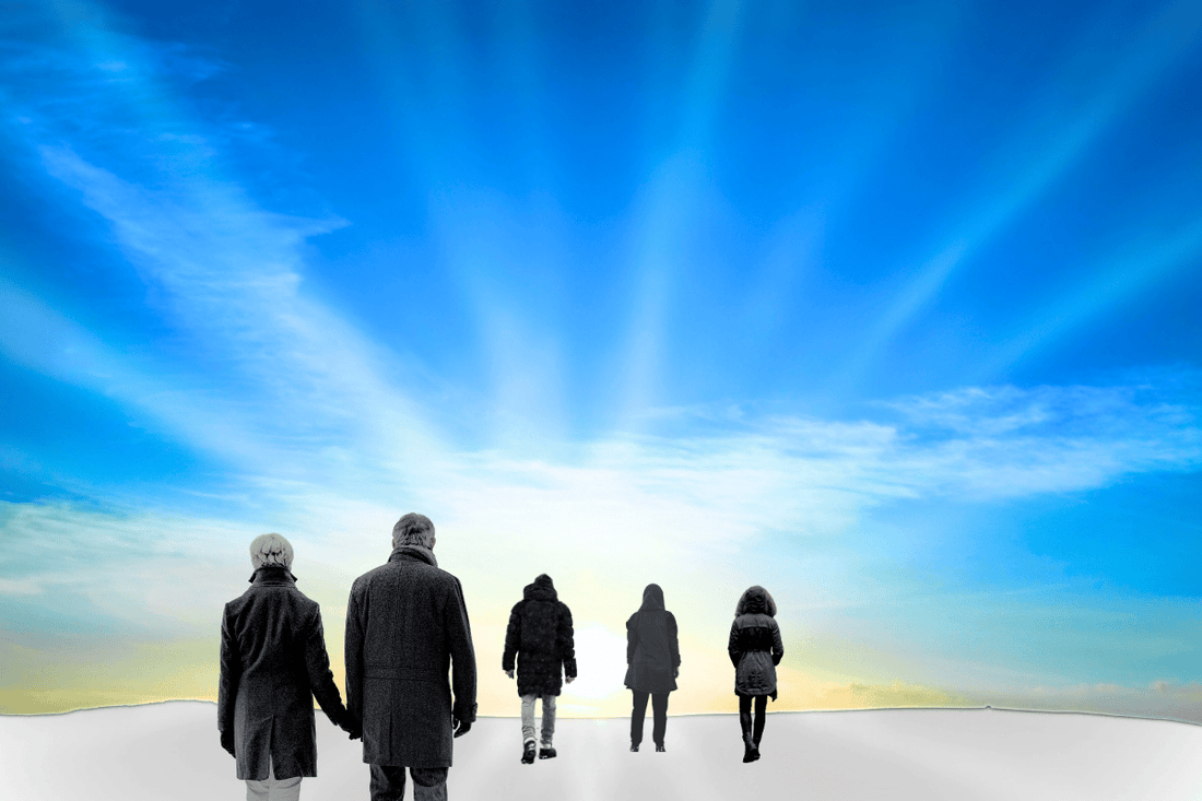 a new year: 5 people going towards the sunrise in the winter